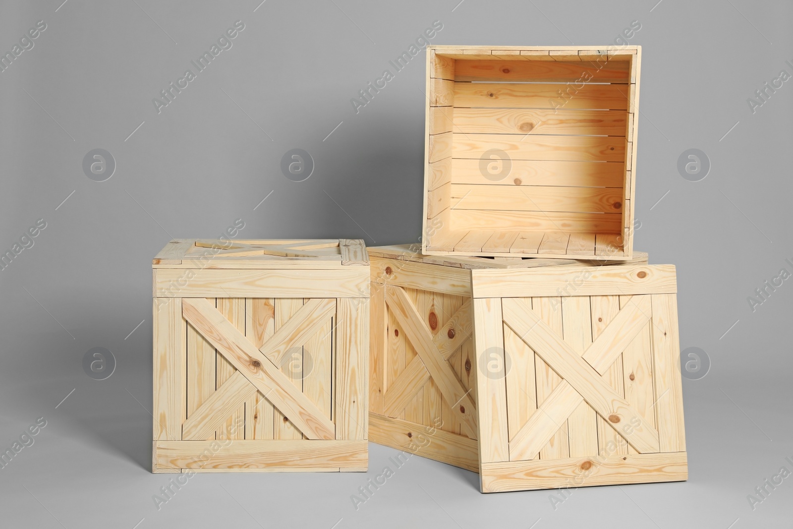 Photo of Group of wooden crates on grey background