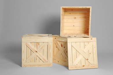 Photo of Group of wooden crates on grey background