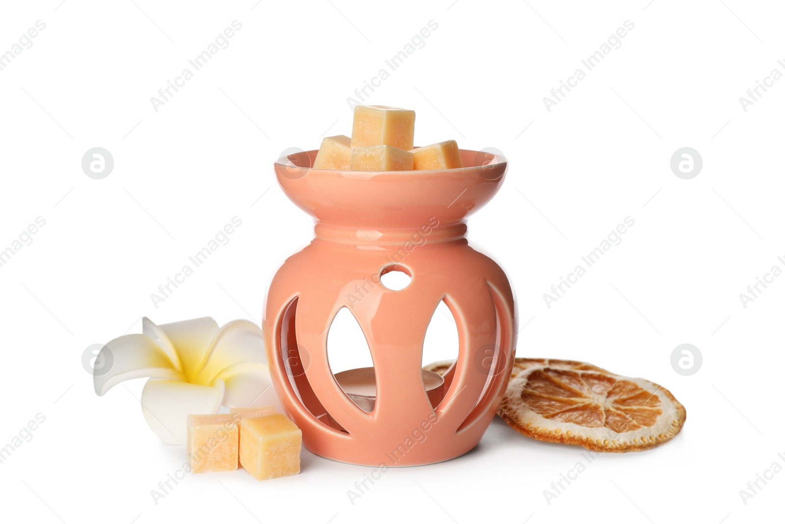 Photo of Stylish aroma lamp with essential wax cubes, flower and dried orange slices on white background