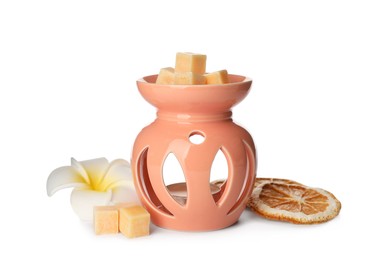 Photo of Stylish aroma lamp with essential wax cubes, flower and dried orange slices on white background