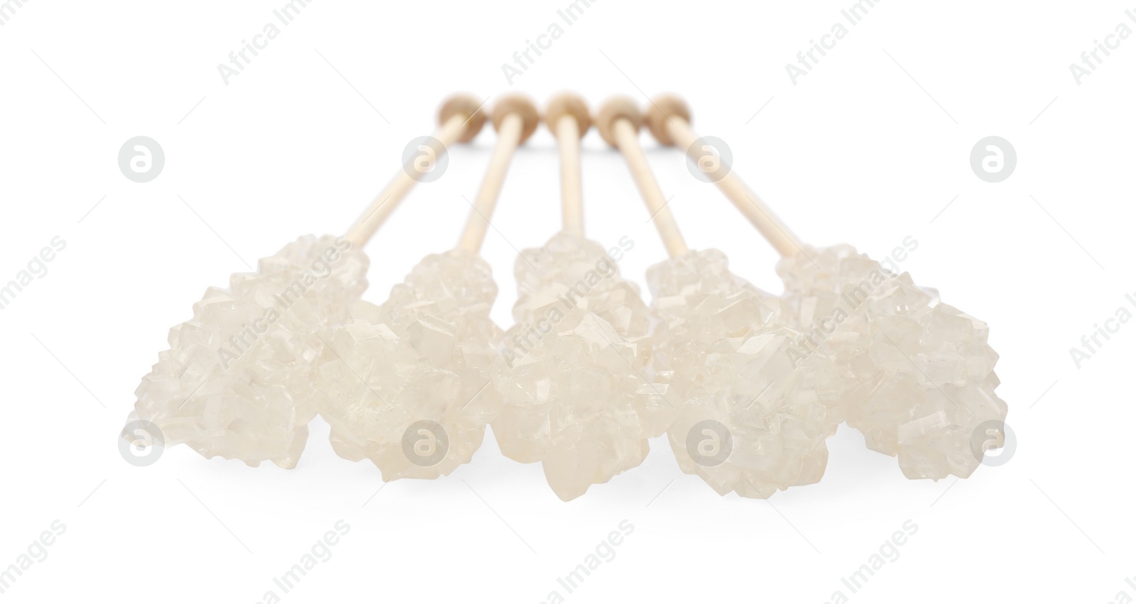 Photo of Wooden sticks with sugar crystals isolated on white. Tasty rock candies