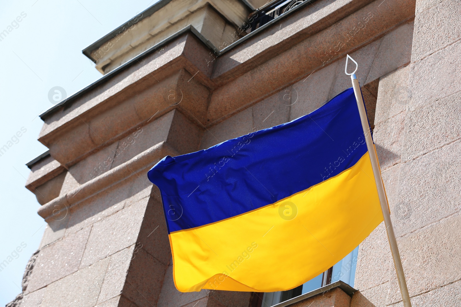 Photo of Flags of Ukraine and Mykolaiv on building facade