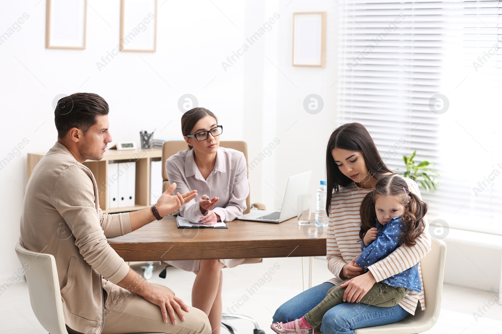 Photo of Professional psychologist working with family in office