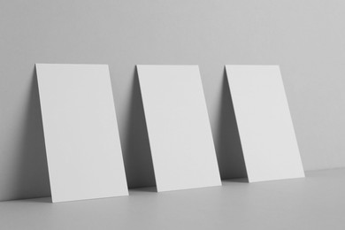 Photo of Blank business cards on light gray background. Mockup for design