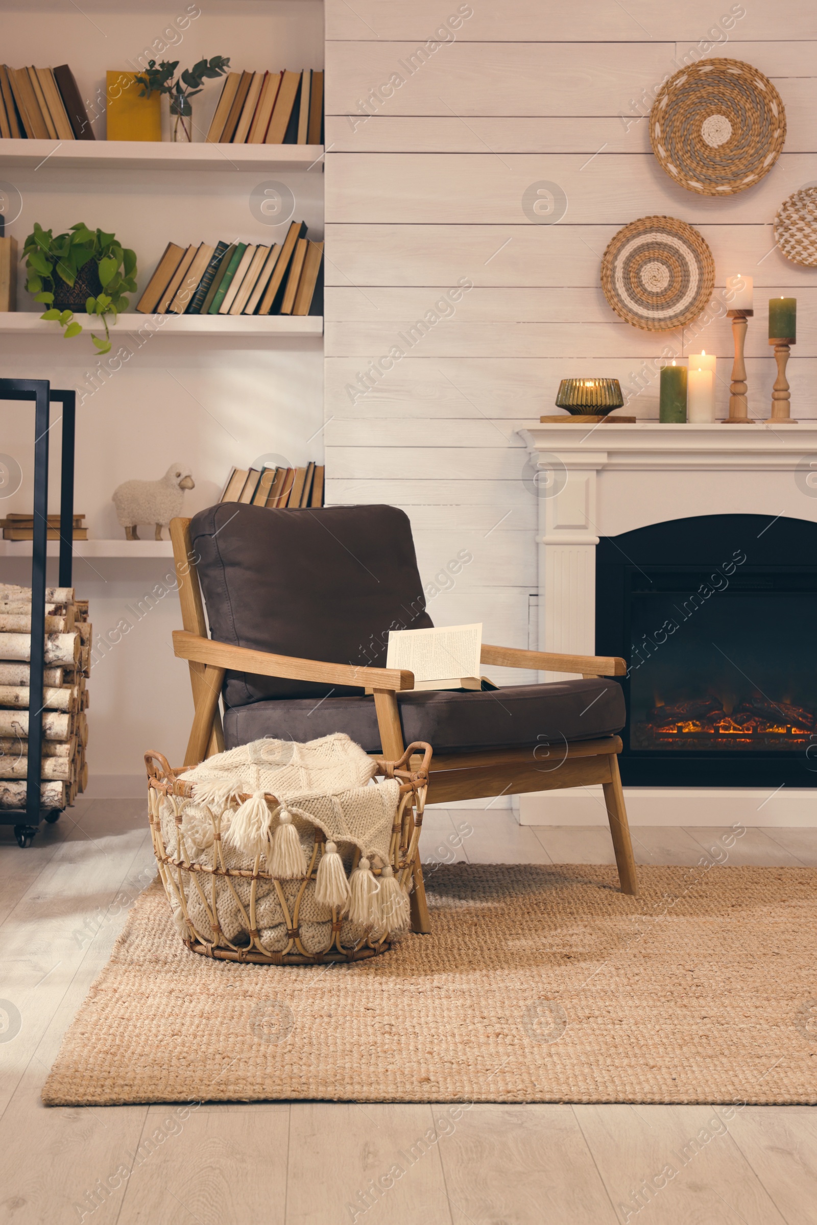 Photo of Cozy living room interior with comfortable armchair near fireplace