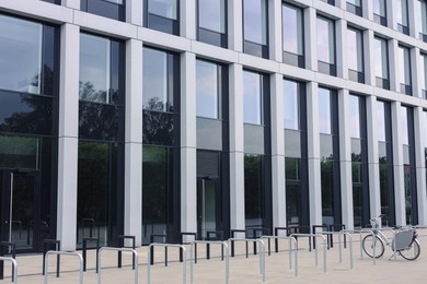 Photo of Beautiful view of bicycle stands near modern building