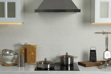 Countertop with different cooking utensils in kitchen