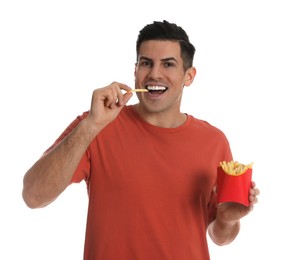 Man eating French fries on white background