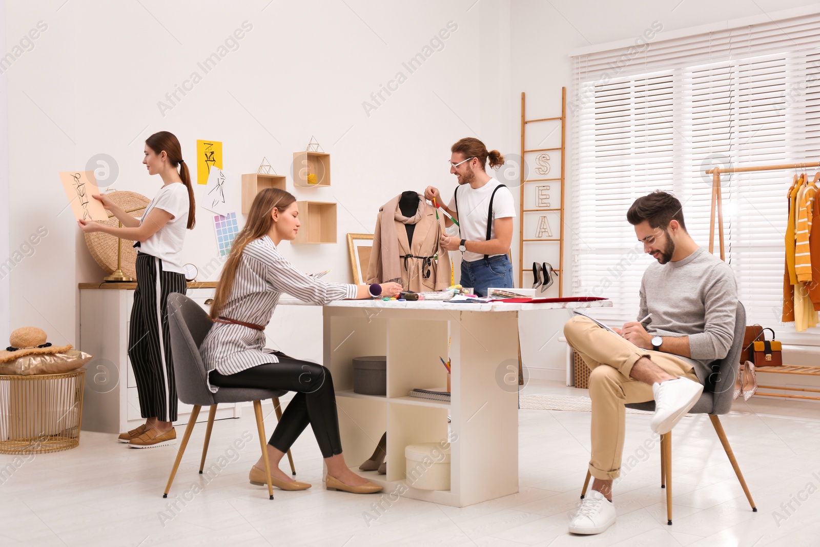 Photo of Fashion designers creating new clothes in studio