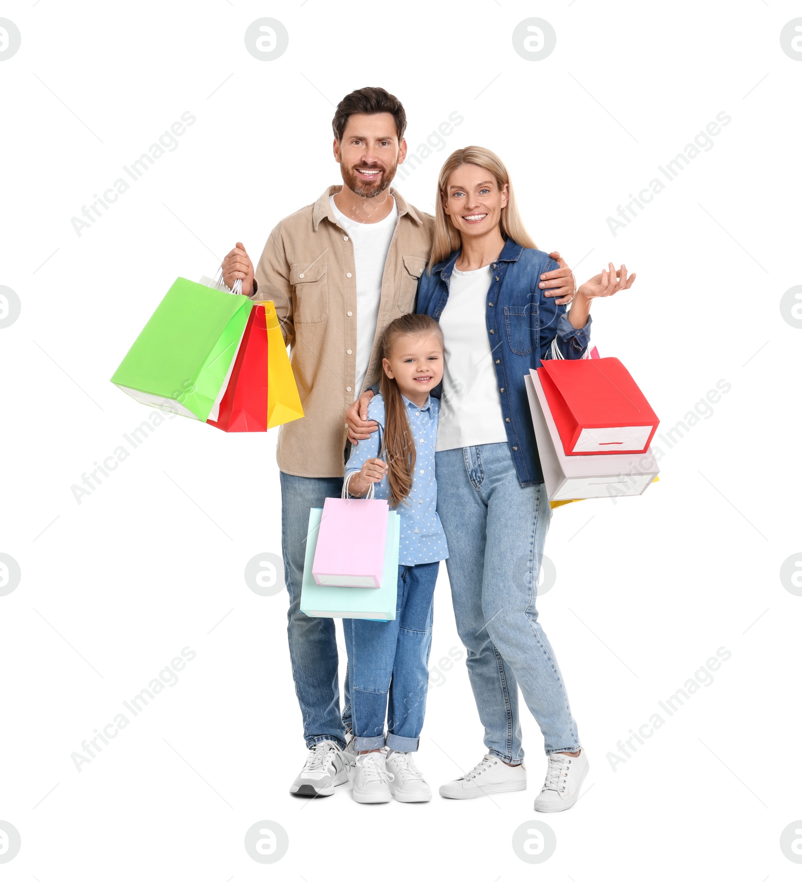 Photo of Family shopping. Happy parents and daughter with many colorful bags on white background