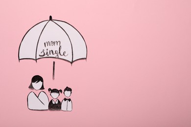 Being single mother concept. Woman with her children under umbrella made of paper on pink background, flat lay and space for text