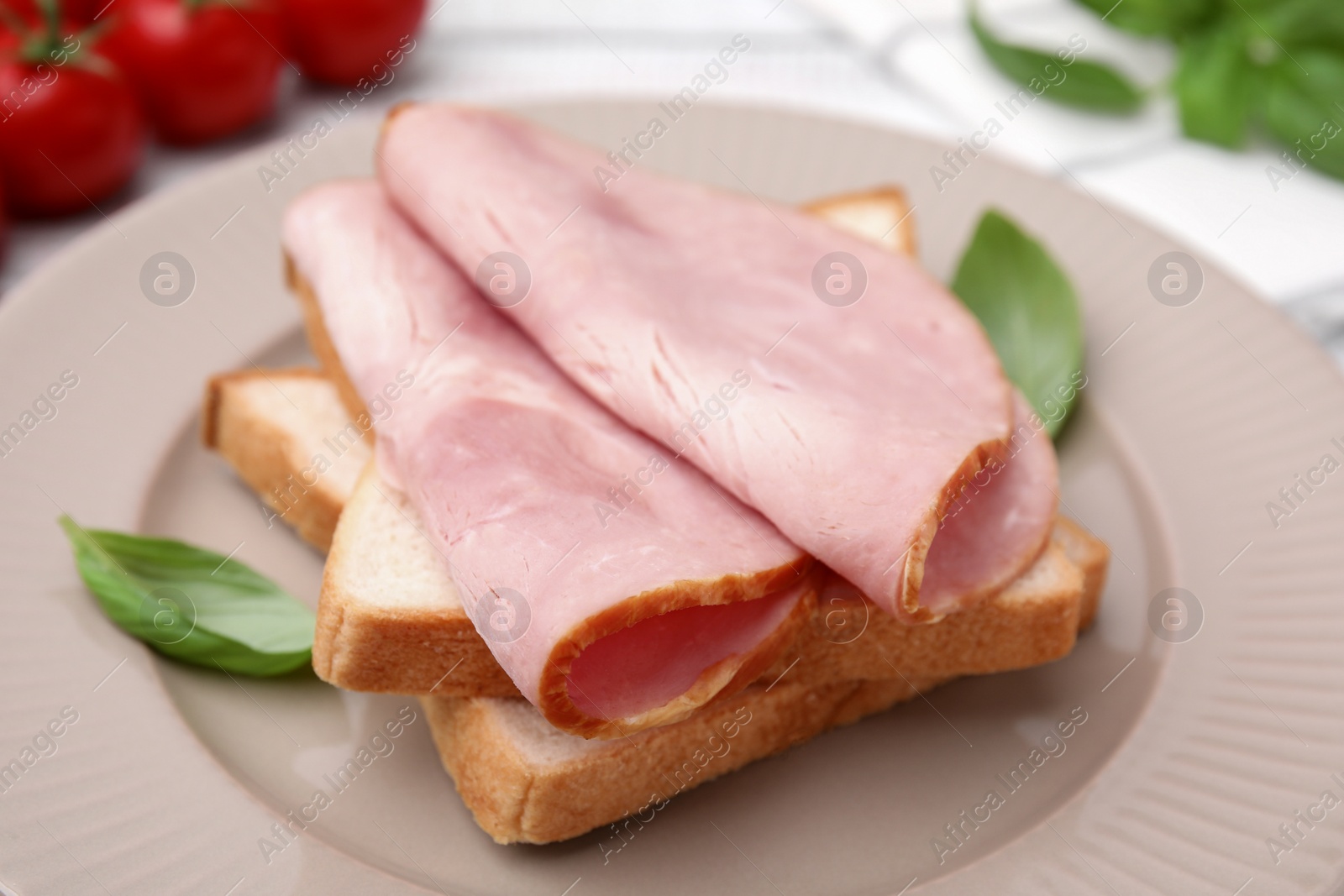 Photo of Delicious sandwich with ham on plate, closeup