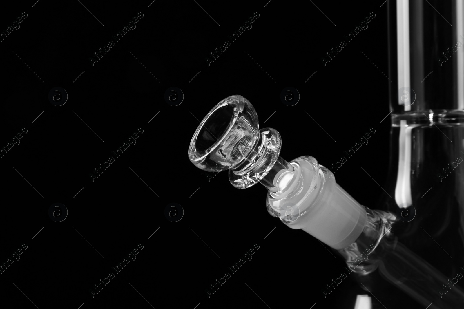 Photo of Closeup view of glass bong on black background, space for text. Smoking device