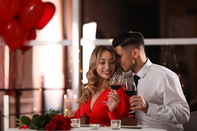 Lovely couple having romantic dinner on Valentine's day in restaurant