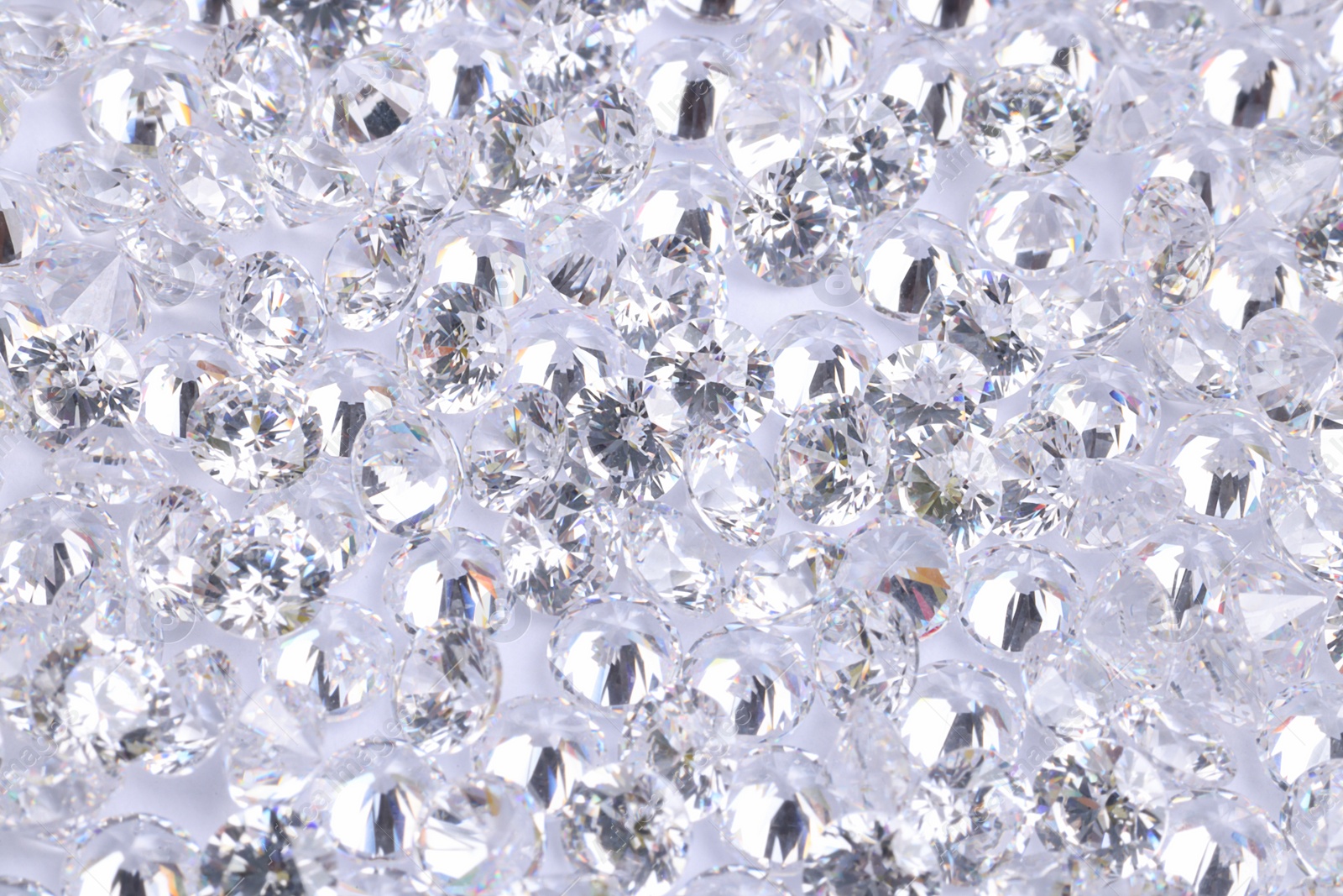 Photo of Many beautiful shiny diamonds as background, above view