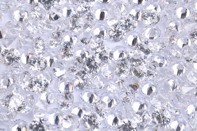 Photo of Many beautiful shiny diamonds as background, above view