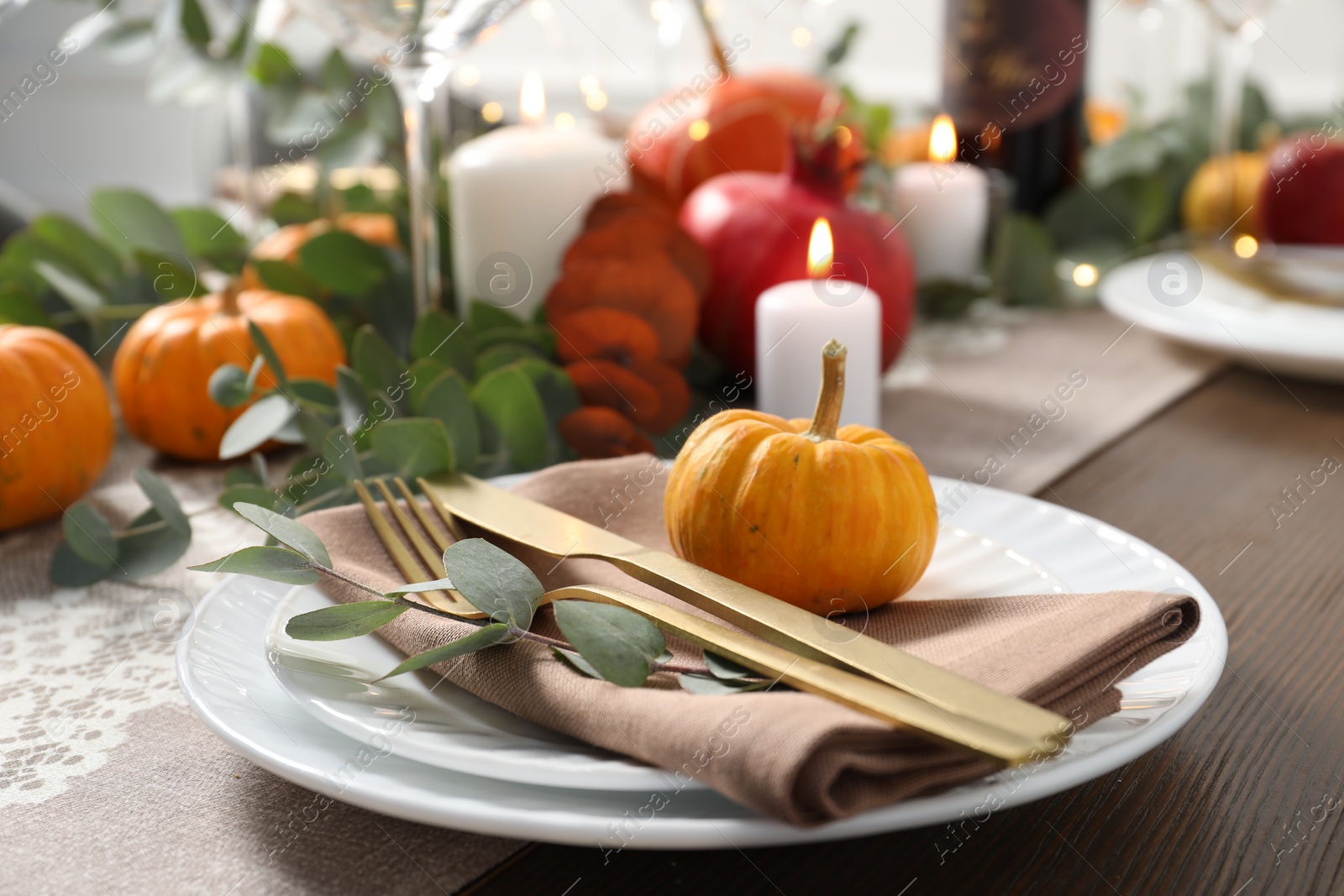 Photo of Autumn table setting, pumpkin and eucalyptus branch, closeup