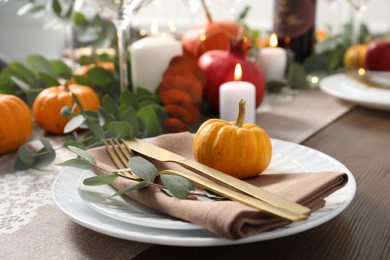 Autumn table setting, pumpkin and eucalyptus branch, closeup