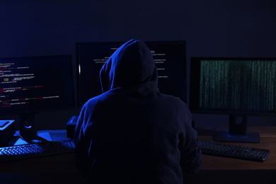 Photo of Hacker with computers in dark room. Cyber crime