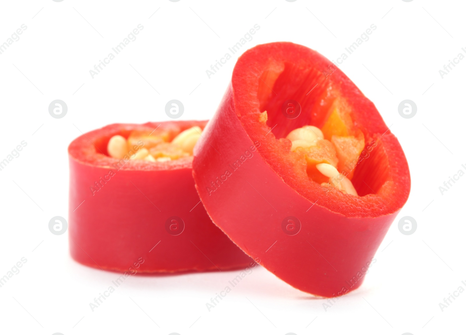 Photo of Slices of red chili pepper on white background