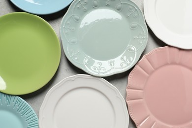 Beautiful ceramic plates on light grey table, flat lay