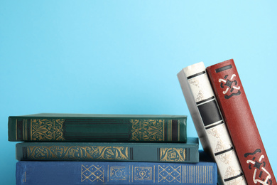 Photo of Collection of old books on light blue background