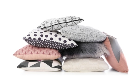 Photo of Pile of different colorful pillows on white background