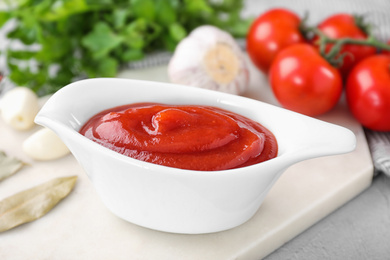 Photo of Delicious tomato sauce on light table, closeup