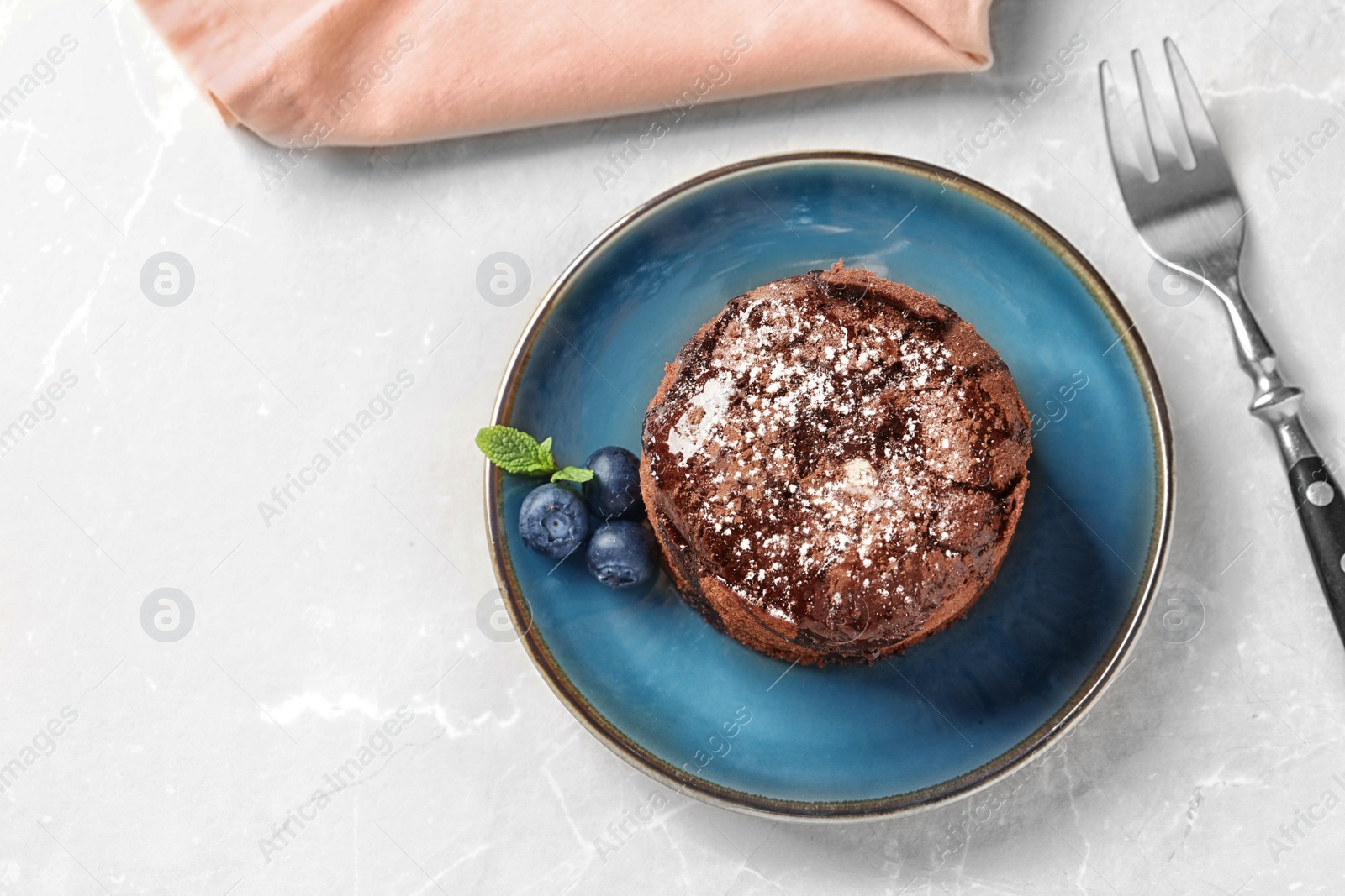 Photo of Plate of delicious fresh fondant with hot chocolate and blueberries on table, top view. Lava cake recipe