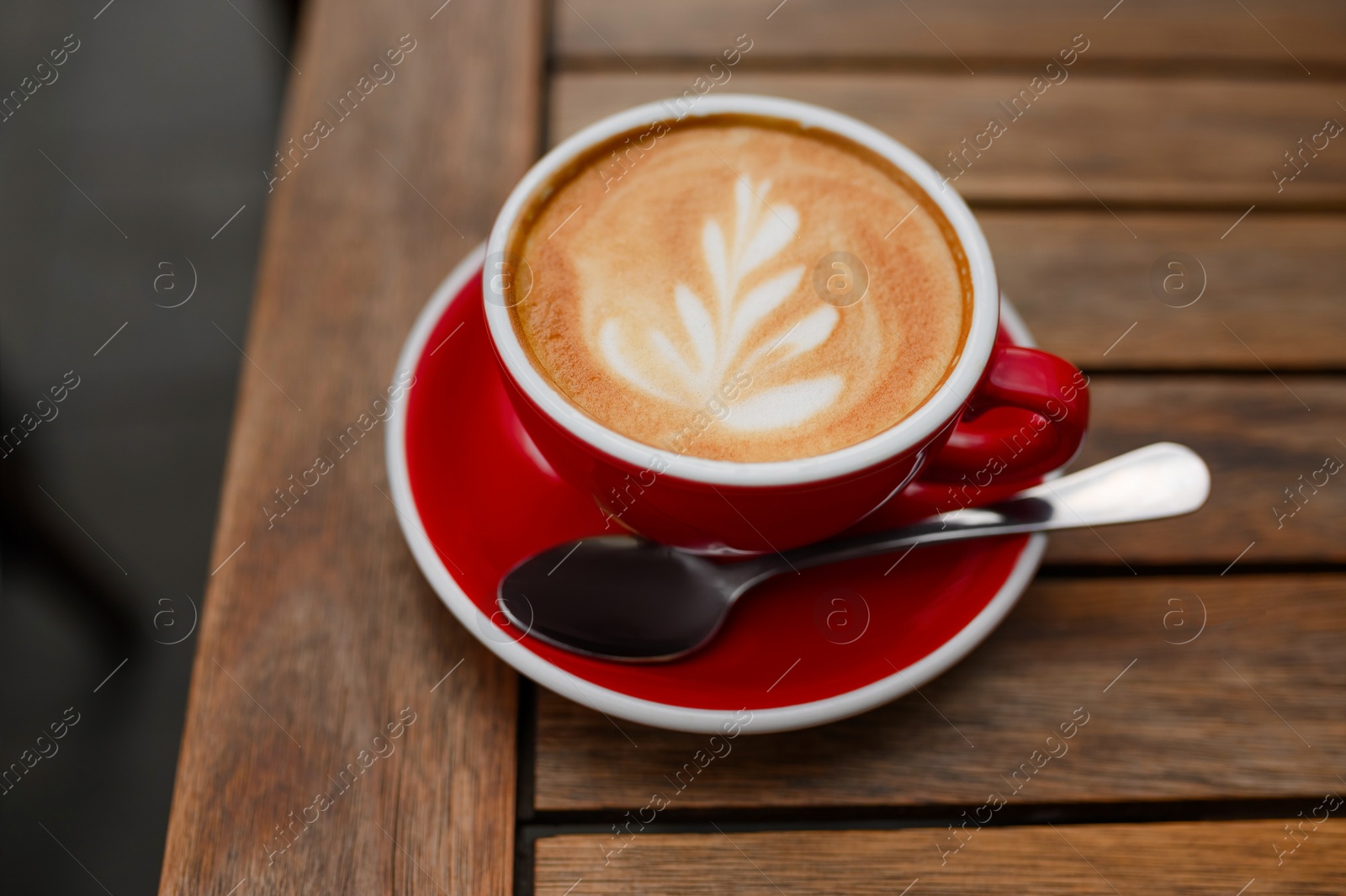 Photo of Cup of aromatic coffee on wooden table