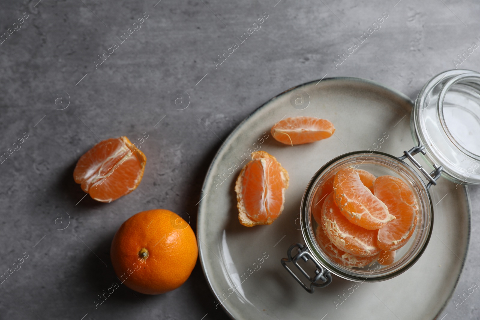 Photo of Fresh ripe tangerines on grey table, flat lay