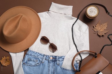 Photo of Flat lay composition with stylish hat and clothes on brown background