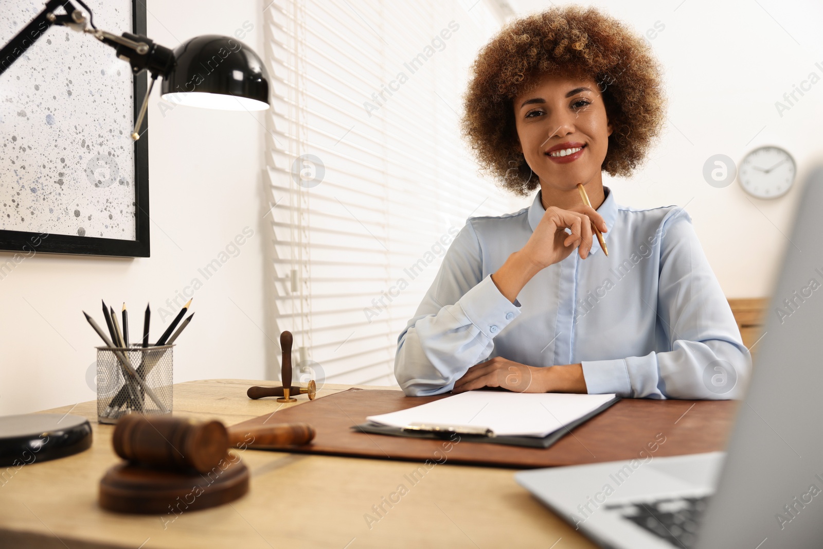 Photo of Notary with clipboard and pen at workplace in office