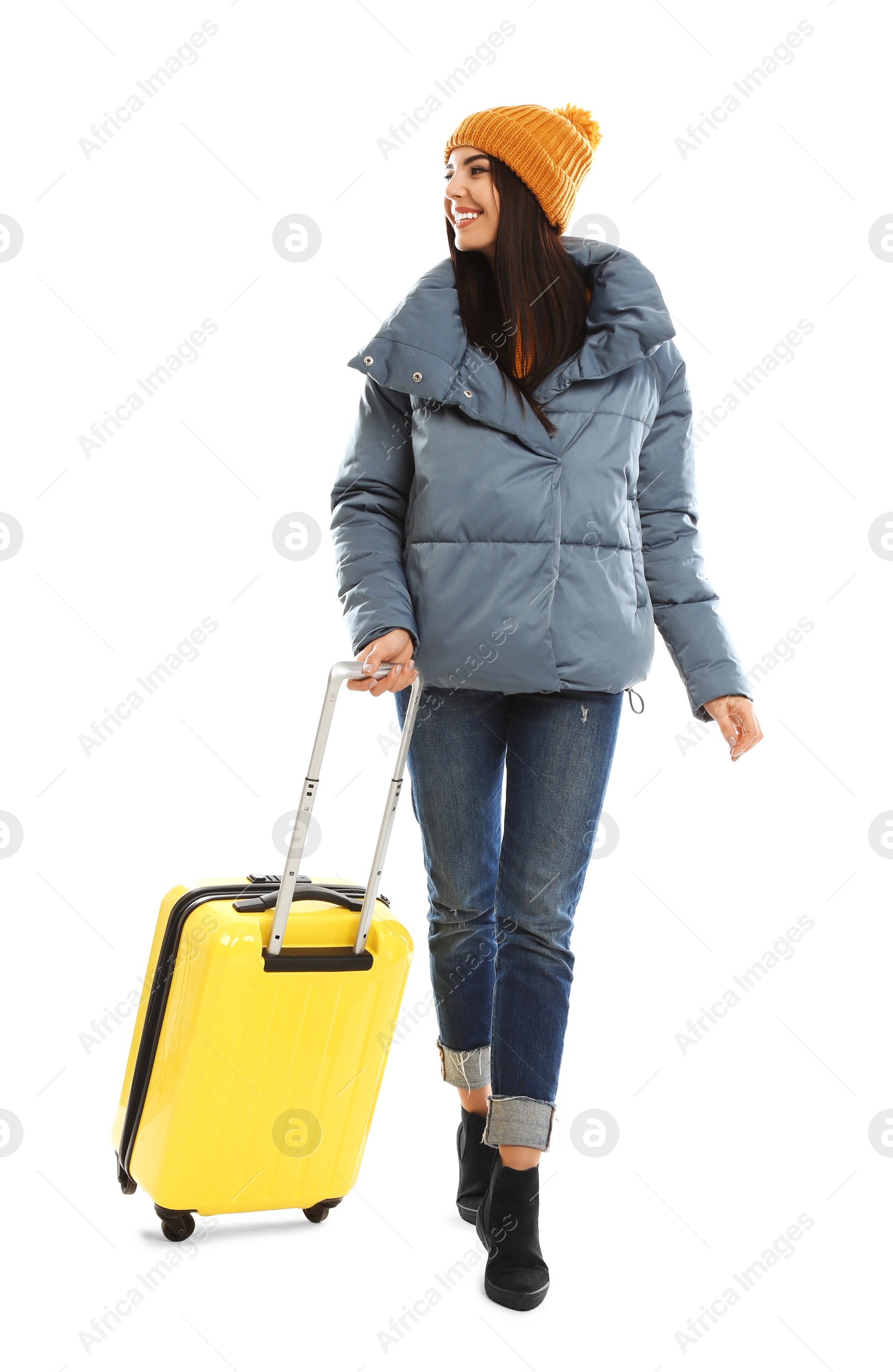 Photo of Young woman in warm clothes with suitcase on white background. Winter vacation