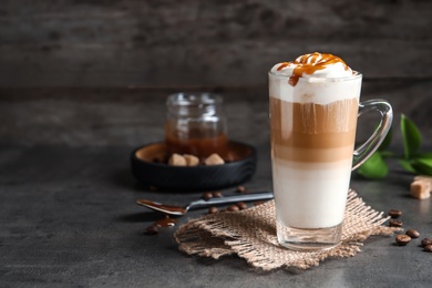 Photo of Glass cup with delicious caramel frappe on table