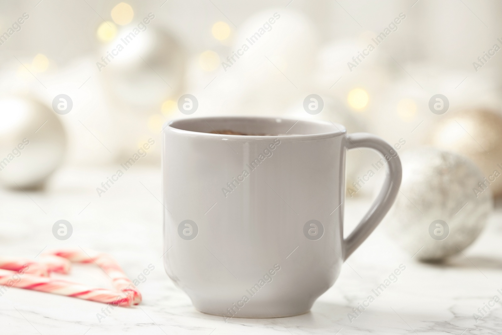 Photo of Cup of hot winter drink on table. Cozy season