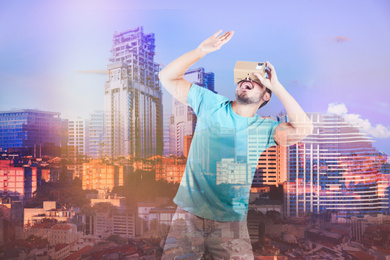 Image of Double exposure of man using virtual reality headset and cityscape. Modern technology