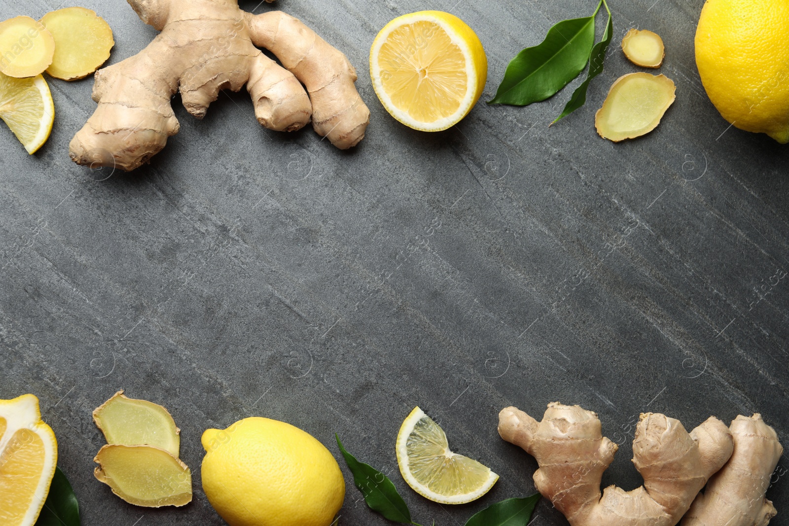 Photo of Frame of fresh lemons and ginger on grey table, flat lay. Space for text