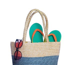 Photo of Beach bag with sunglasses and flip flops isolated on white
