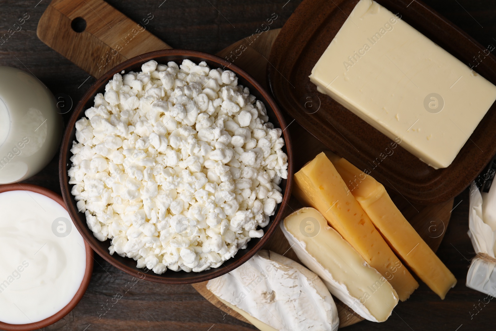 Photo of Different fresh dairy products on wooden table, flat lay