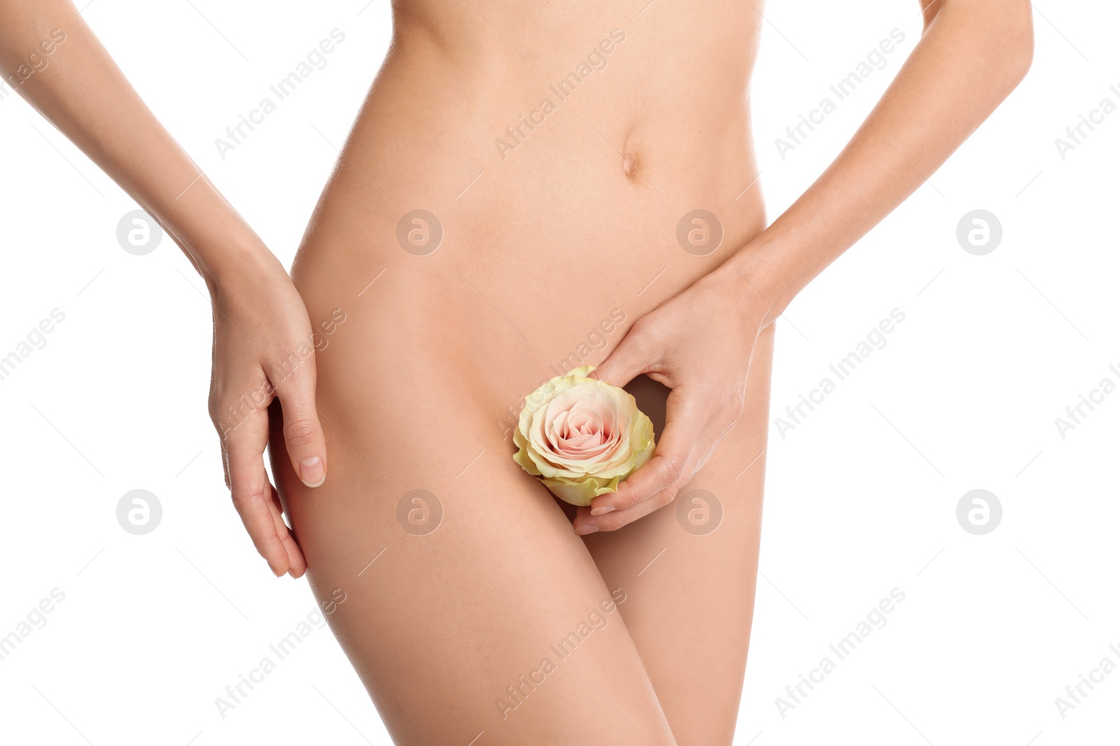 Photo of Woman with flower showing smooth skin after Brazilian bikini epilation on white background, closeup. Body care concept