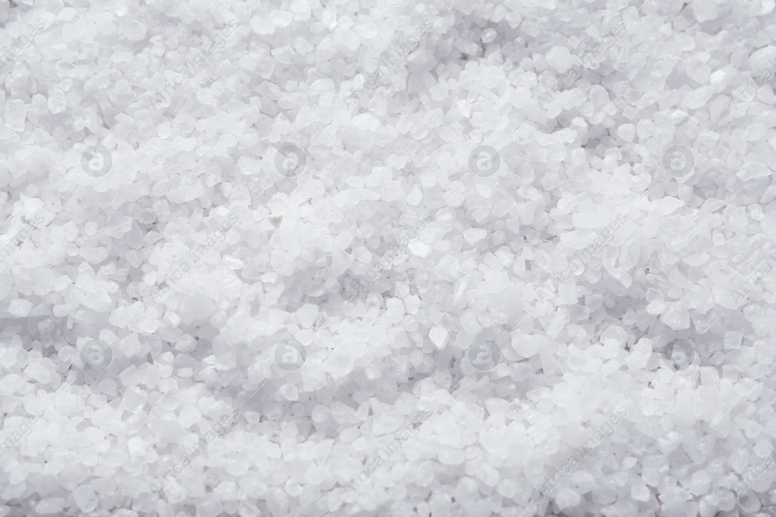 Photo of Natural sea salt as background, top view