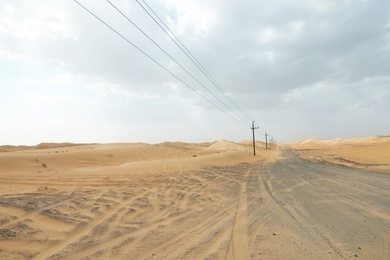 Electricity transmission line near road in desert