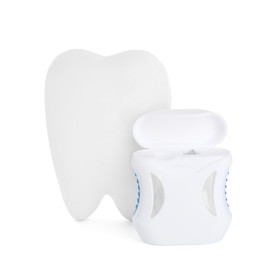 Photo of Tooth shaped holder and dental floss on white background