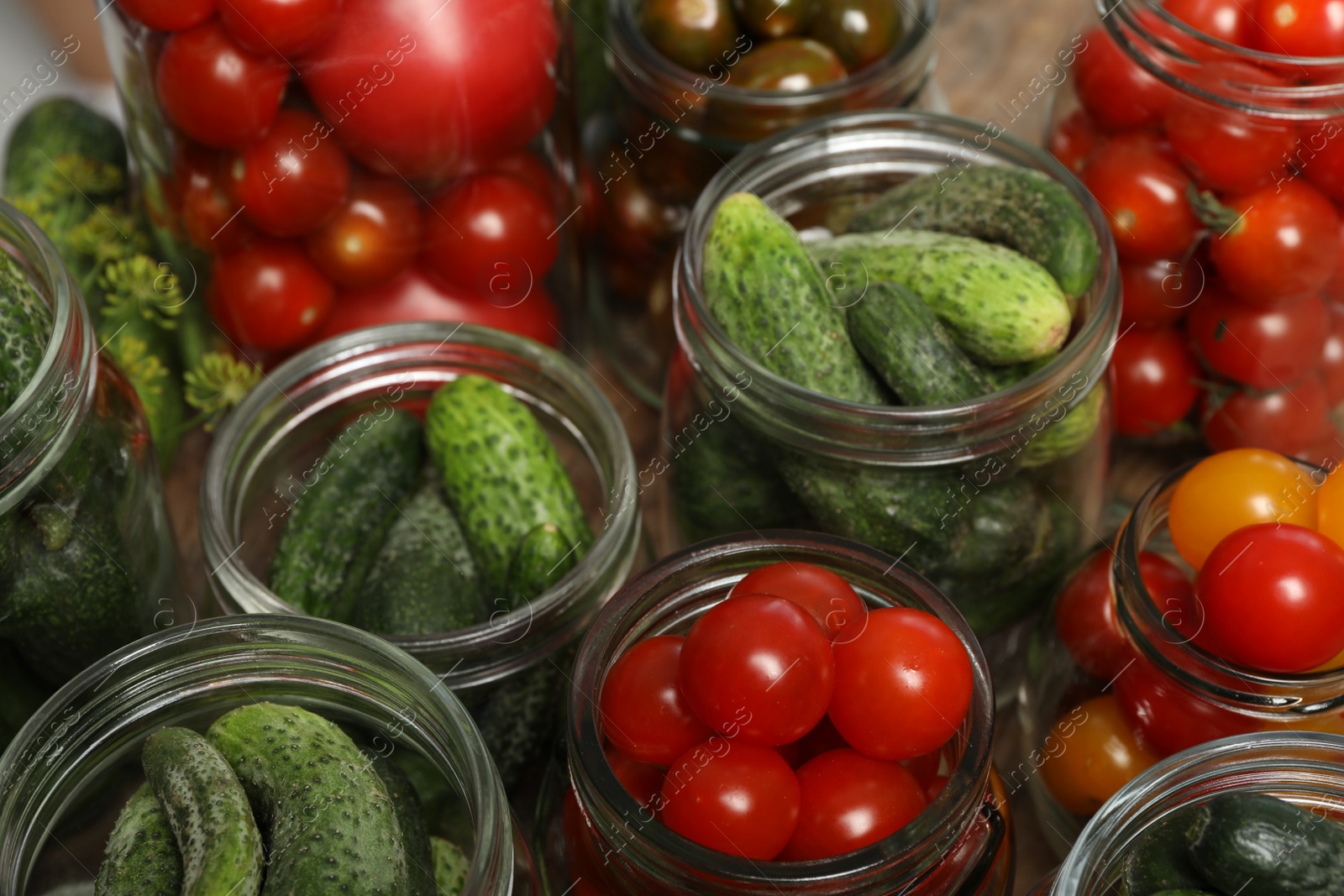 Photo of Pickling jars with fresh vegetables, closeup view