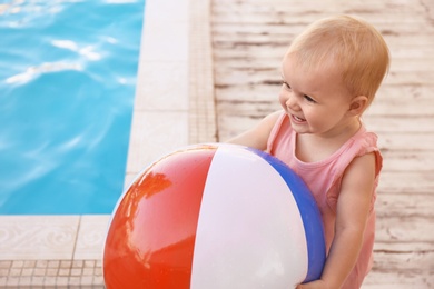 Photo of Little baby playing near outdoor swimming pool. Dangerous situation