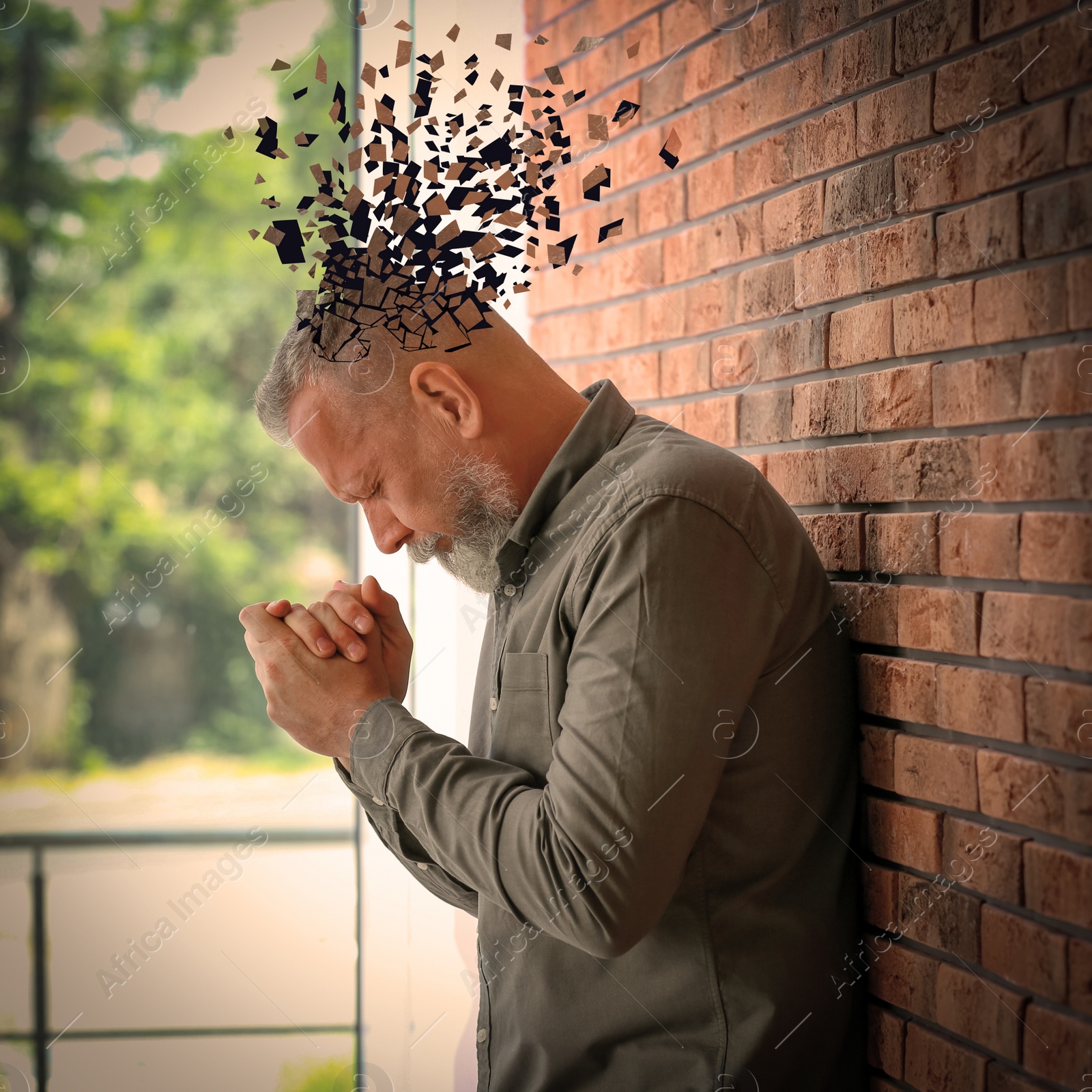 Image of Senior man suffering from dementia indoors. Illustration of head falling apart into shards
