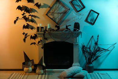 Photo of Stylish room with fireplace decorated for Halloween