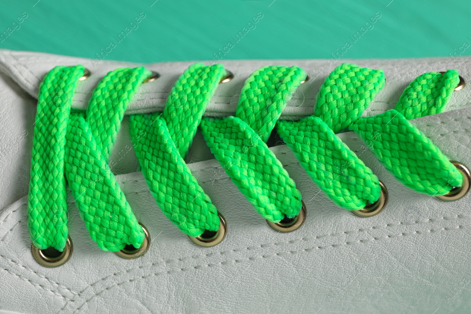 Photo of Stylish shoe with green laces, closeup view