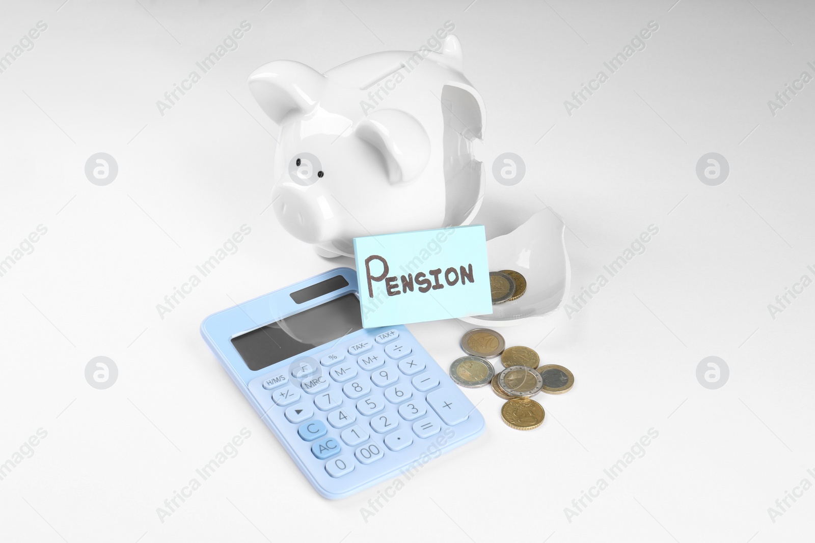 Photo of Calculator, card with word Pension, broken piggy bank and coins on white background. Retirement concept